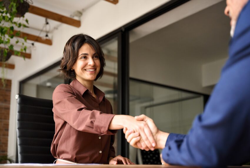 Happy,Young,Business,Woman,Bank,Manager,Handshaking,Client,At,Meeting.